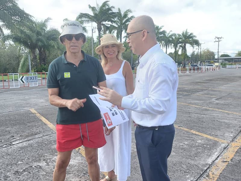 Ted Li assisting passengers with transfer details on the ground at Rassada Pier